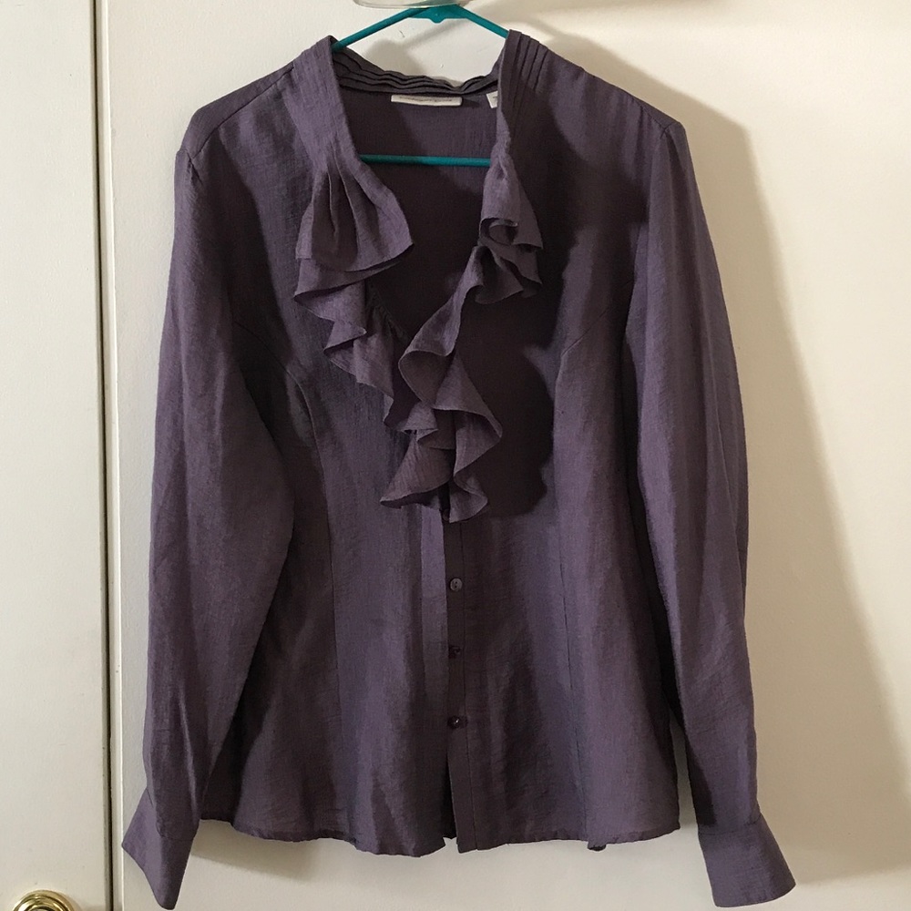 Purple button up shirt with ruffles.